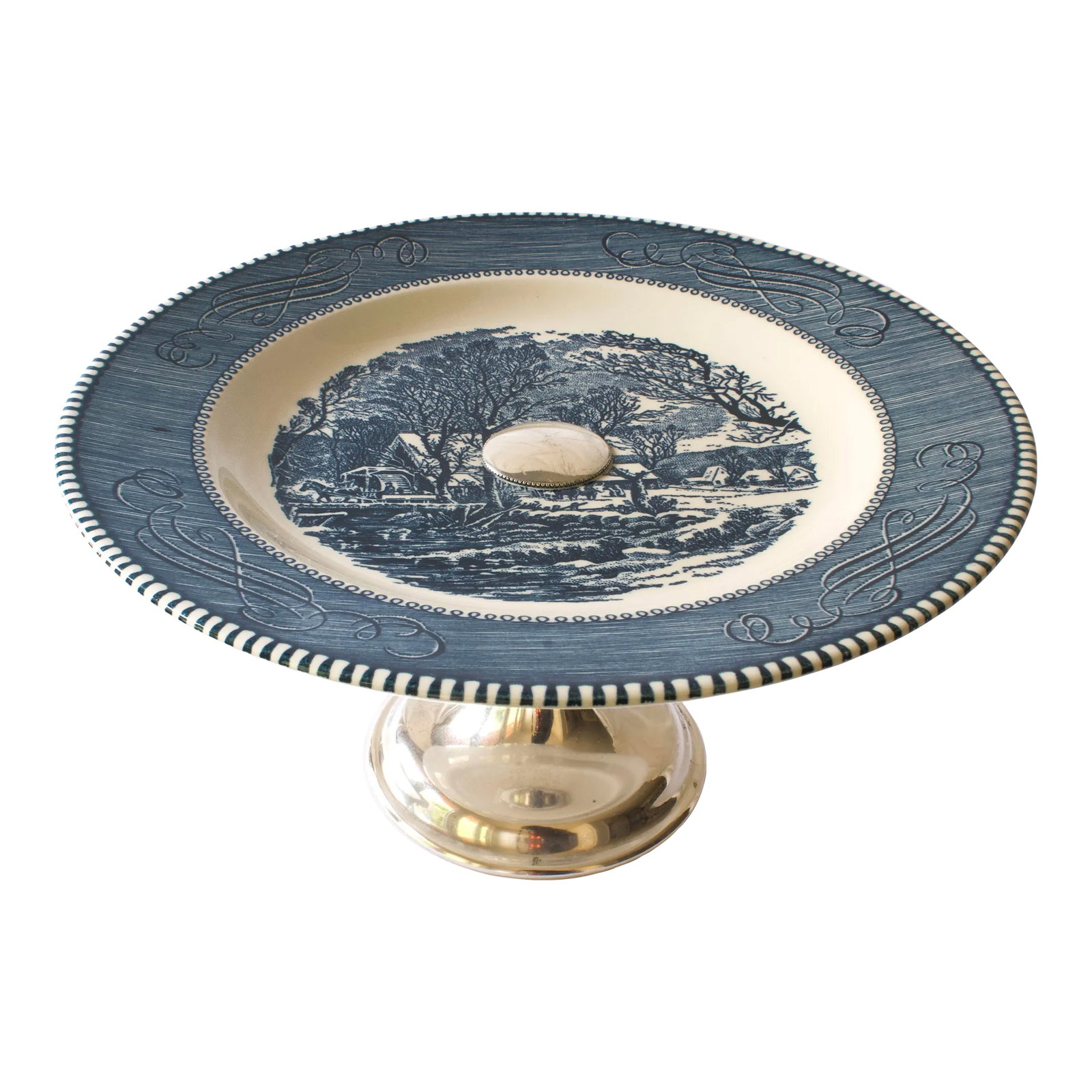 Mid 20th Century Currier & Ives Cake Stand: This vintage transferware cake stand is in amazing condition and oozes vintage charm. I haven't come across another one like this! The plate is attached to a silver plated base. This is an American cl