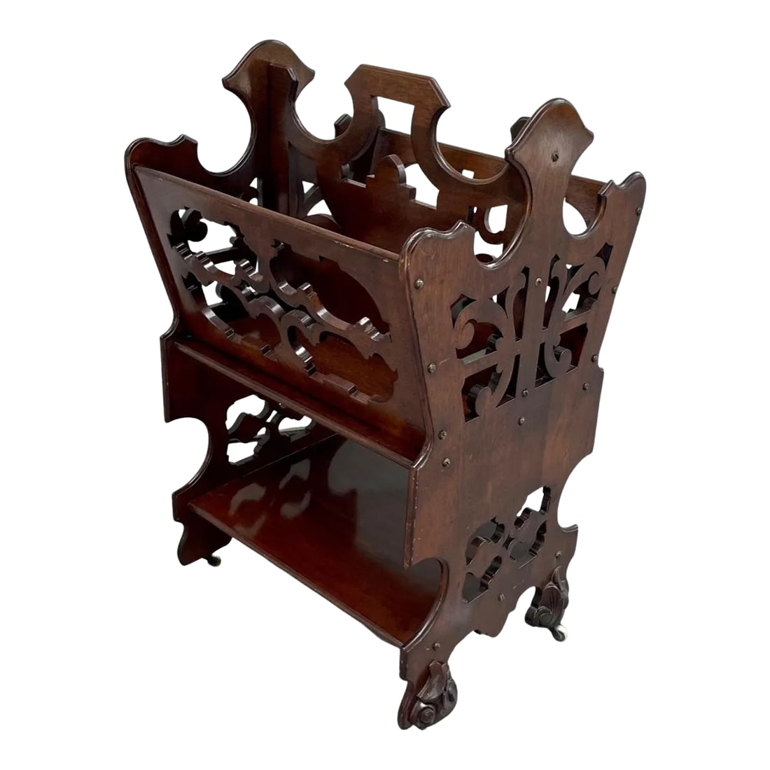 English Victorian Two Tier Walnut Canterbury Circa 1880.: English Victorian Two Tier Walnut Canterbury circa 1880. Victorian period 1880 canterbury in solid walnut with hand carved scrollwork. This two tiered rolling magazine rack features ornate, pierced wo