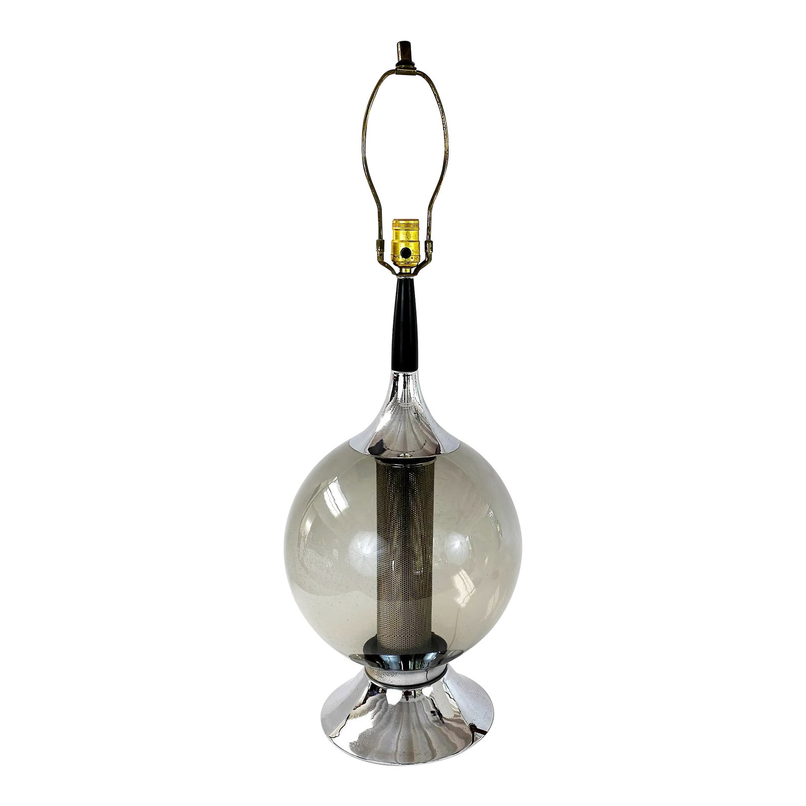 Vintage Mid-Century Smoky Glass and Chrome Table Lamp: Vintage Mid-century smoky glass globe lamp with base and top pieces in chrome and a wood neck painted in black. It presents an internal mesh grill with a candelabra base bulb, that emits a warm light.