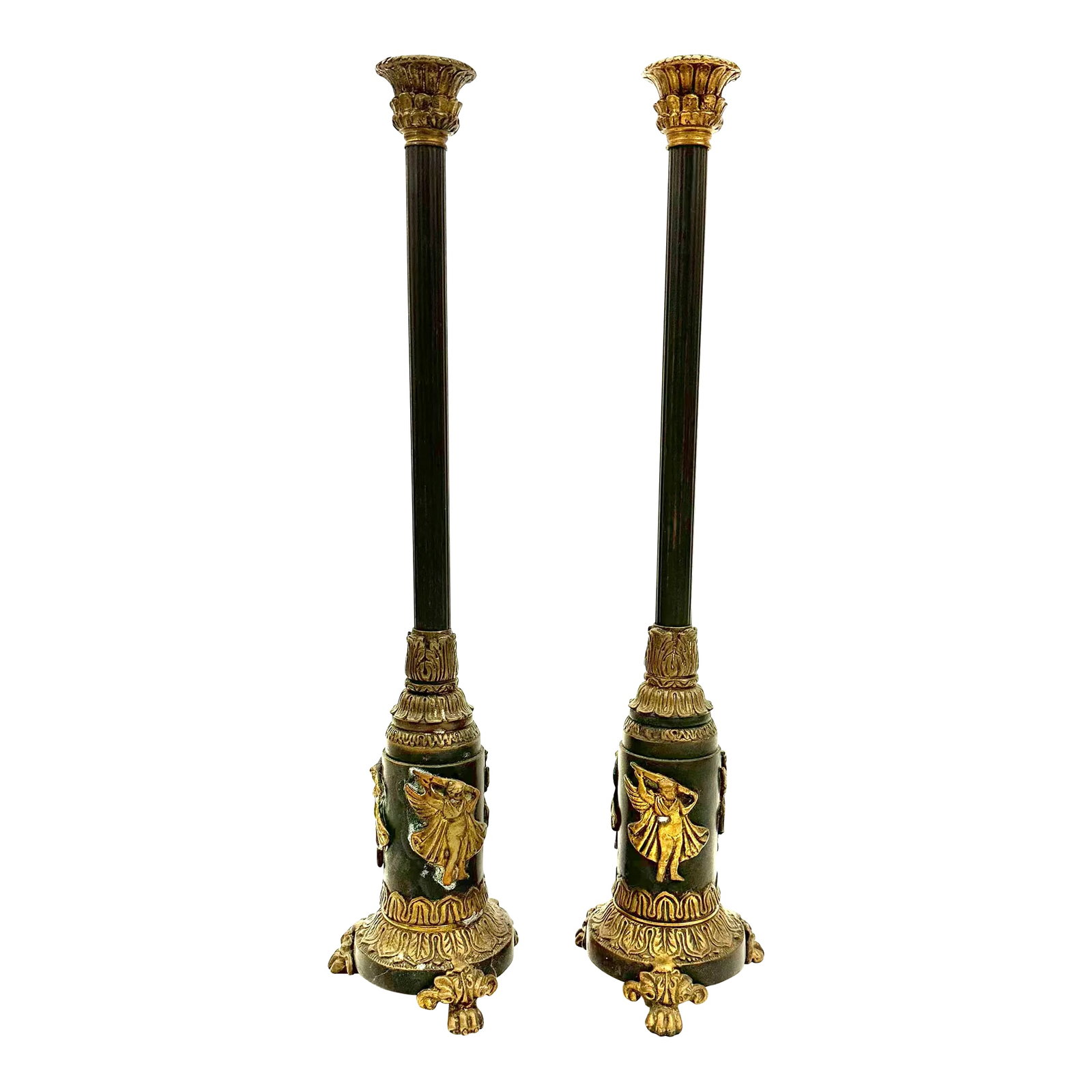 1940s Neoclassical Revival Bronze and Brass Candlesticks- a Pair: These heavy 18" tall bronze and brass candlesticks sit on three small paw feet. The ribbed black stalk rest on a 2.5" diameter base with three brass appliques depicting a capped boy with a sword. The