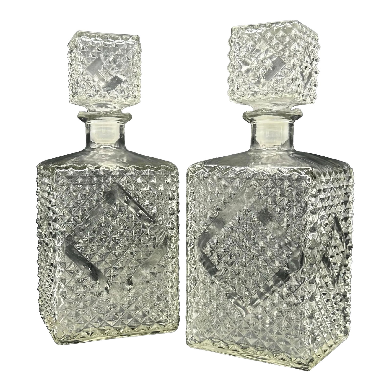 Vintage 1960s Diamond Accented Glass Decanters, Pair: Beautiful pressed glass decanters with stoppers. Condition: Alterations: Original Condition Unaltered Imperfections: Some Imperfections Condition Notes: The plastic stopper on one of them has