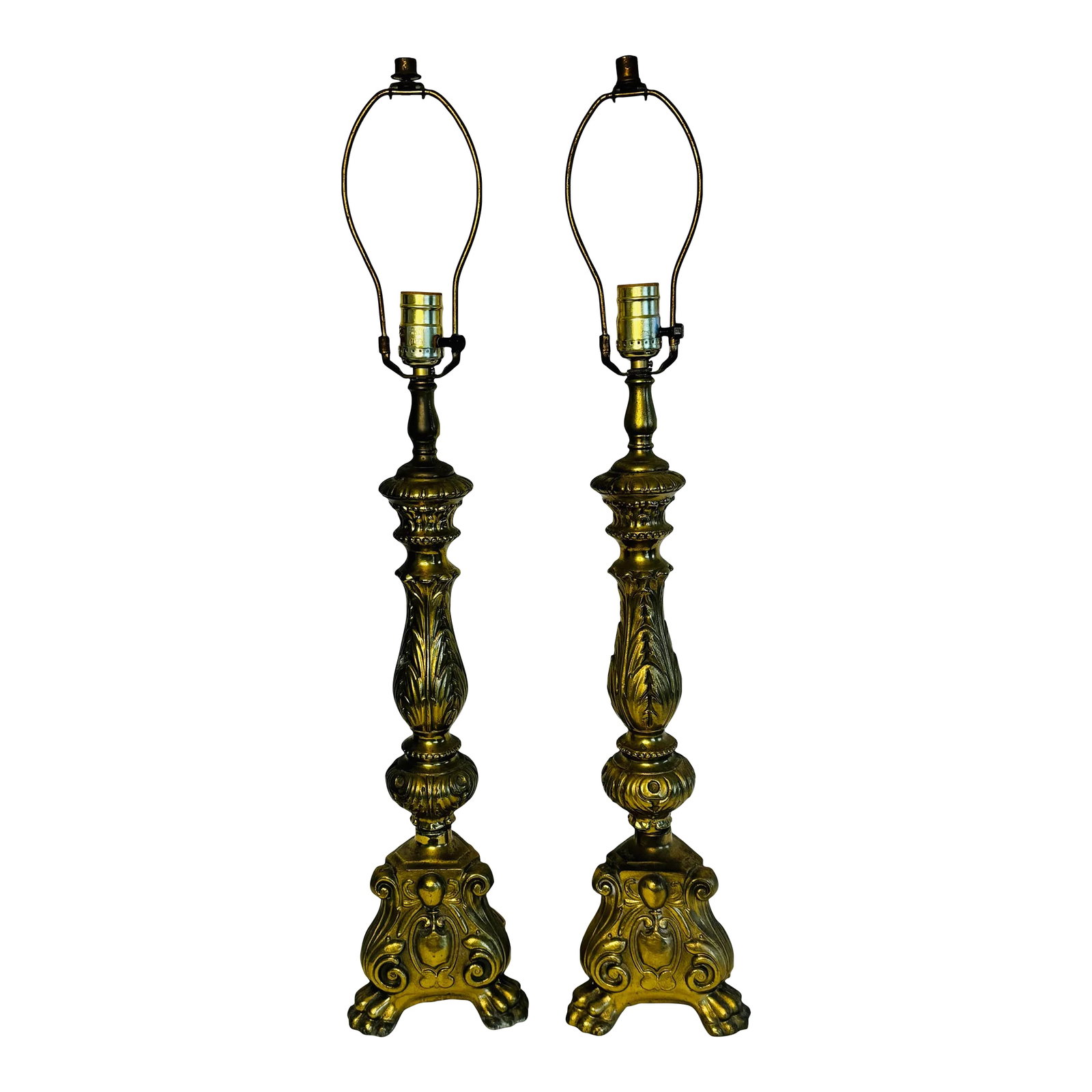 Vintage 1950s Solid Brass Claw Foot Table Lamps, a Pair: Vintage 1950s pair of solid brass table lamps with claw feet. The bases of the lamps are triangular and the lamps are decorated all over with leaves a crest. Wired for the US and in working