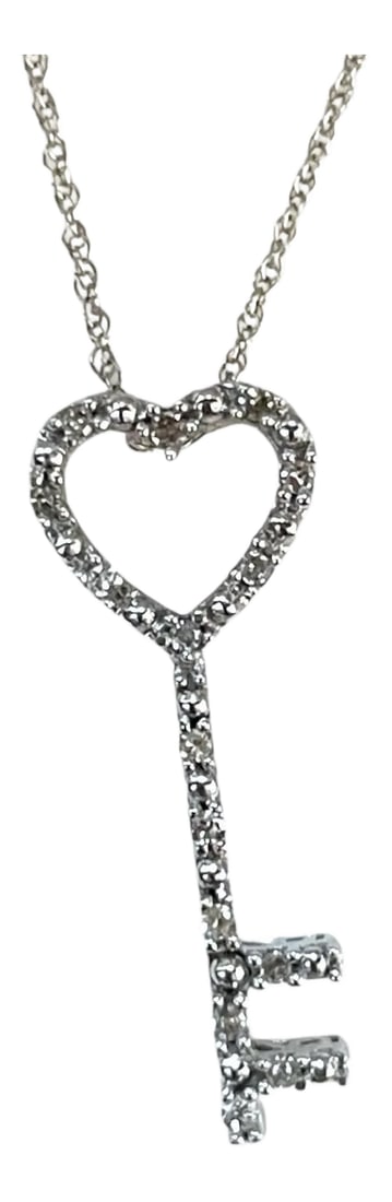10k White Gold Heart-Key Pendant With Diamonds: Unlock the beauty of love and elegance with this stunning white gold pendant, designed in the shape of a delicate key. The heart-shaped top is encrusted with shimmering diamonds, making it a symbol