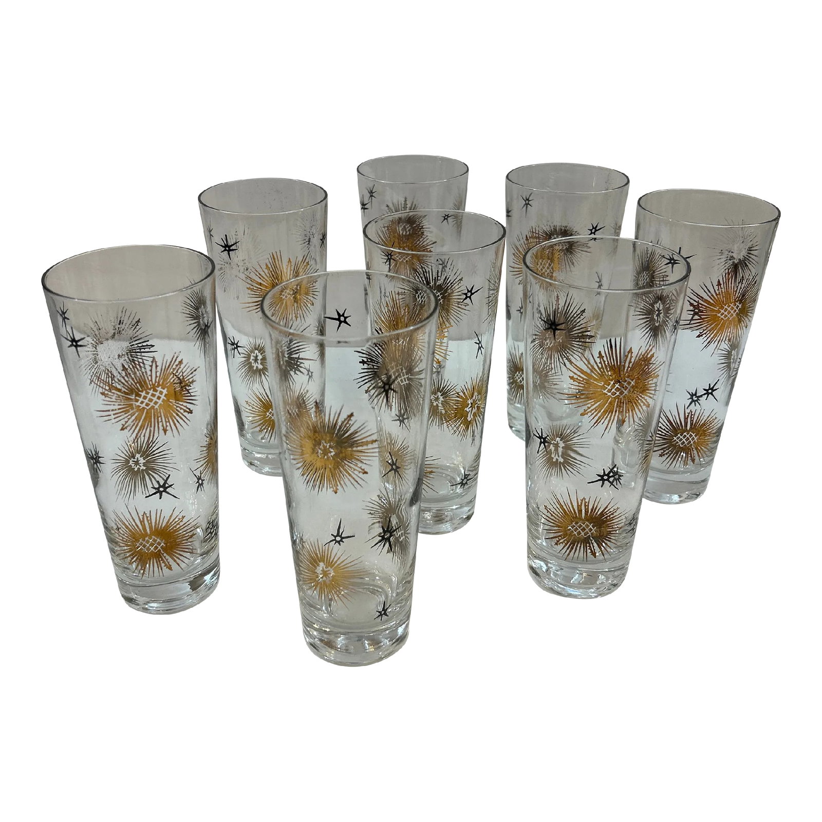 1950s Black and Gold Tapered Starburst Cocktail Drinking Glasses Set of 8: Set of 8 midcentury modern 1950s black and gold starburst cocktail glasses. They're tall and tapered with wonderful period star designs in black and gold. A wonderful set of 8 rarely found in excellen