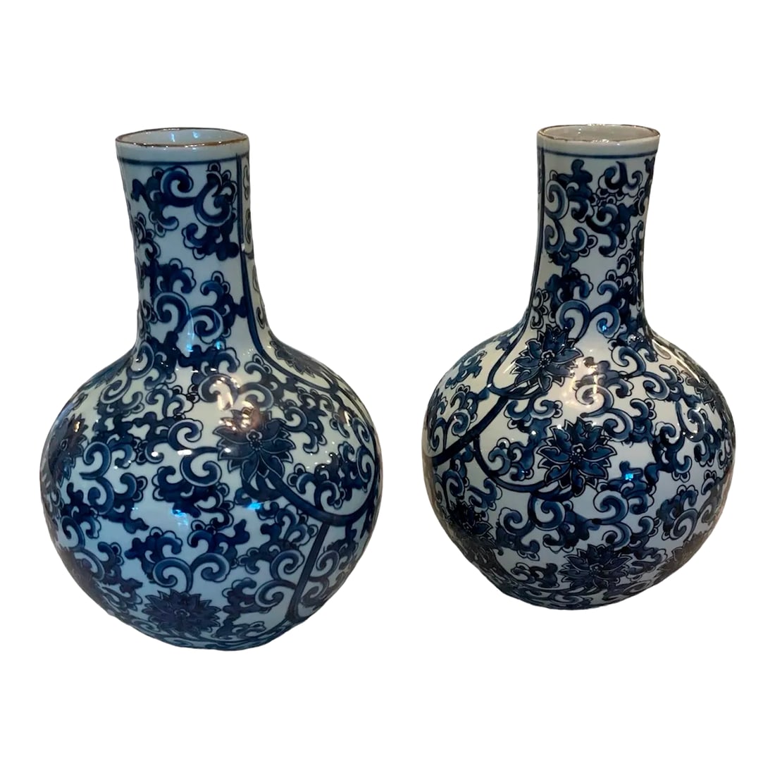 Pair of Blue & White Floral Vases: Add a touch of timeless elegance to your home decor with this Pair of Blue & White Floral Vases. These beautifully crafted vases feature a classic blue and white color scheme adorned with delicate