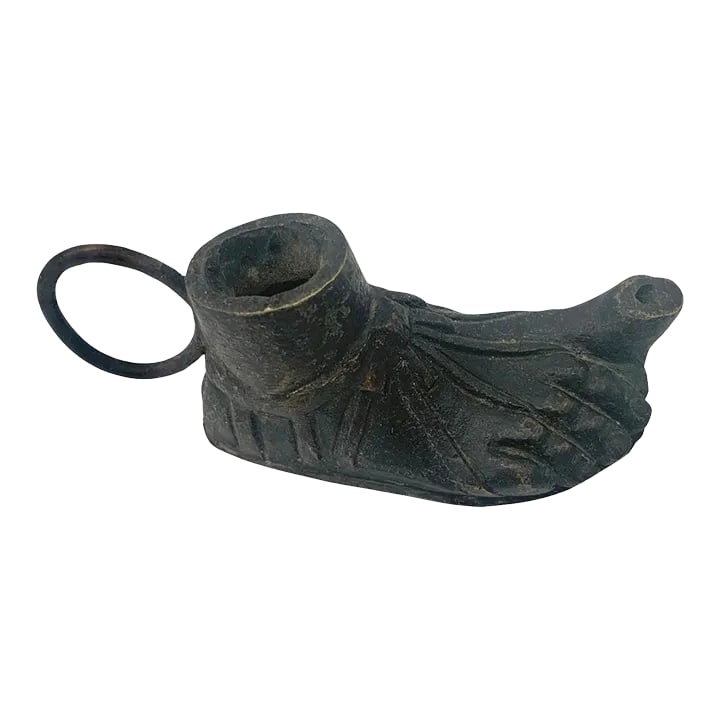 Antique Cast Iron Oil Lamp in the Shape of a Foot: This small cast iron oil lamp made in the form of a foot in a sandal is an example of the Orientalist style and thought of as a Grand Tour souvenir. The sandal "sole" is brass. Unmarked. Size: 4.75"