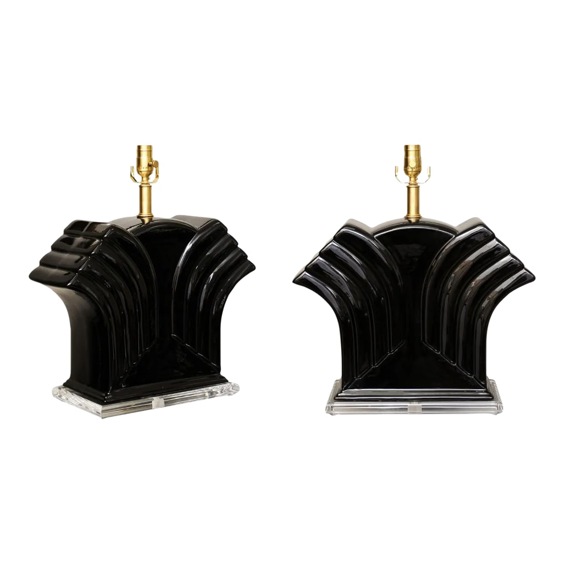 Pair of Vintage Art Deco Black Porcelain Lamps on Lucite: Very sleek pair of glazed black deco forms on lucite bases most likely from the late 1960s.. The lucite is original and in excellent condition. The pitted hardware has been replaced with solid brushed