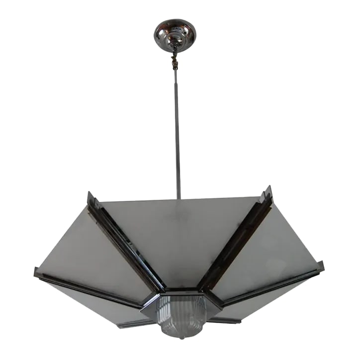 1970s Art Deco Polished Chrome Pendant: Phenomenal Art Deco Revival chandelier is a vision in polished chrome and frosted glass. Razor-sharp fins hold the glass pieces in place, and it's finished off with a dramatic pressed glass cup in