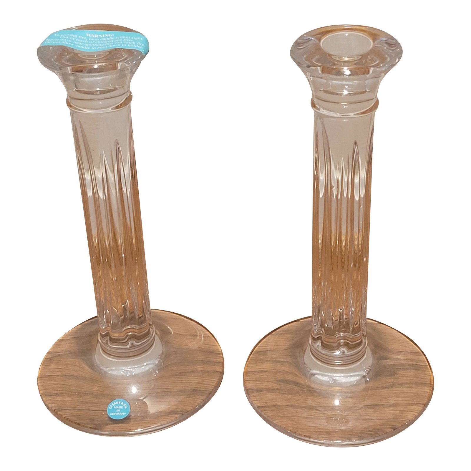 Tiffany & Co. Crystal Candlesticks - a Pair: Never used pair of Tiffany & Co. Crystal Candlesticks Measures: 4.5"W x 4.5"D x 8.5"H. Candlestick contains the original sealed Tiffany & Co blue tag on base and tape on top. Comes with the original