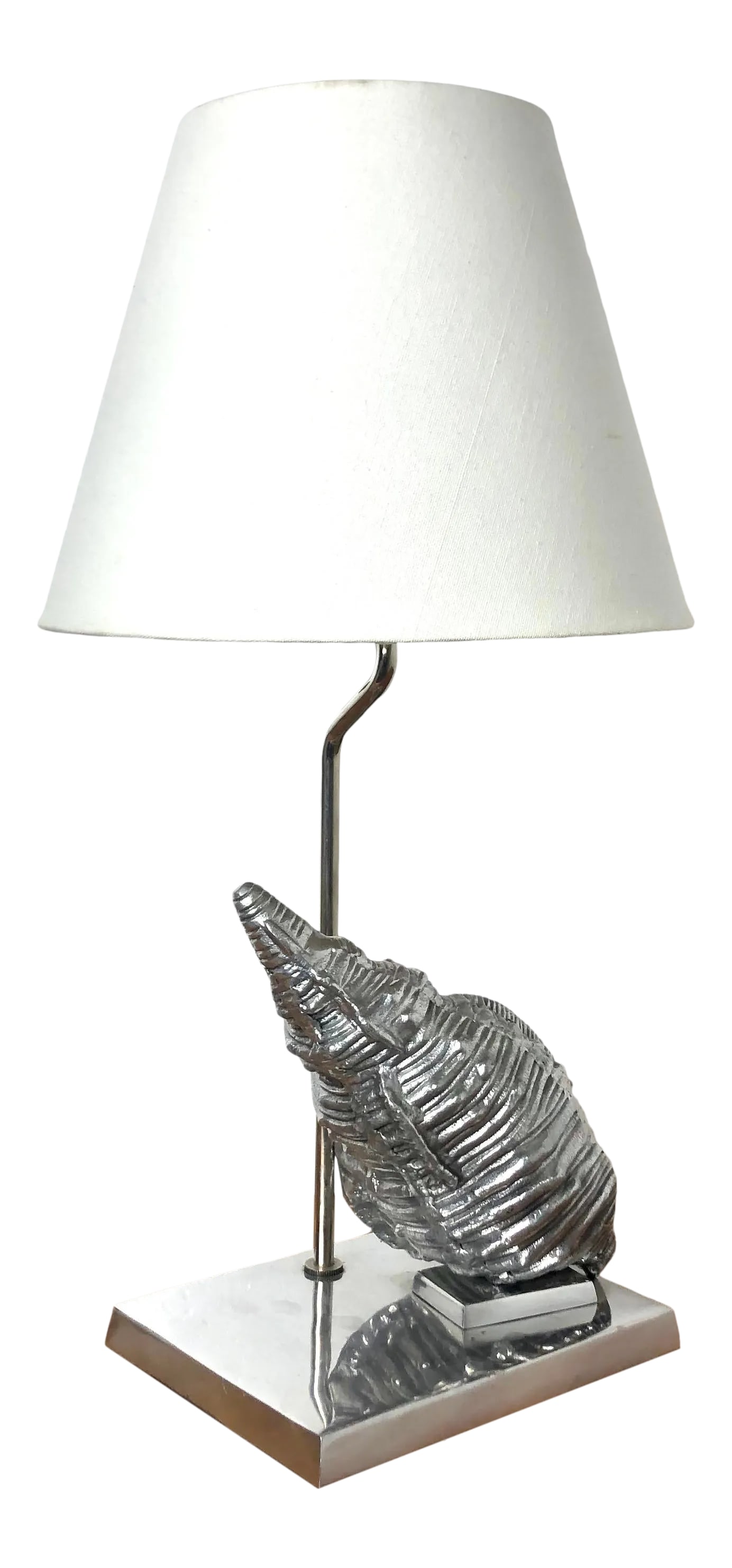 Frederick Cooper Coastal Sea Shell Table Lamp: By Fredrick Cooper of Chicago, solid chromed metal conch shell on a chrome base. Original shade included. Smaller size makes it ideal for a hallway, corner lamp or desk lamp. On/off switch on cord. DI