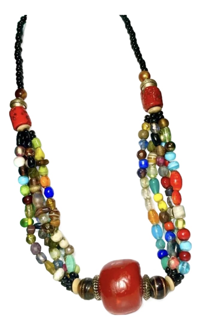 North African Trade Beads and Large Phenolic Cherry Red Copal Resin: North African trade beads and large phenolic cherry red copal resin bead 25mmx20mm. Early 20th century glass beads, coral, and silver disc beads. The necklace is composed of many, many African glass