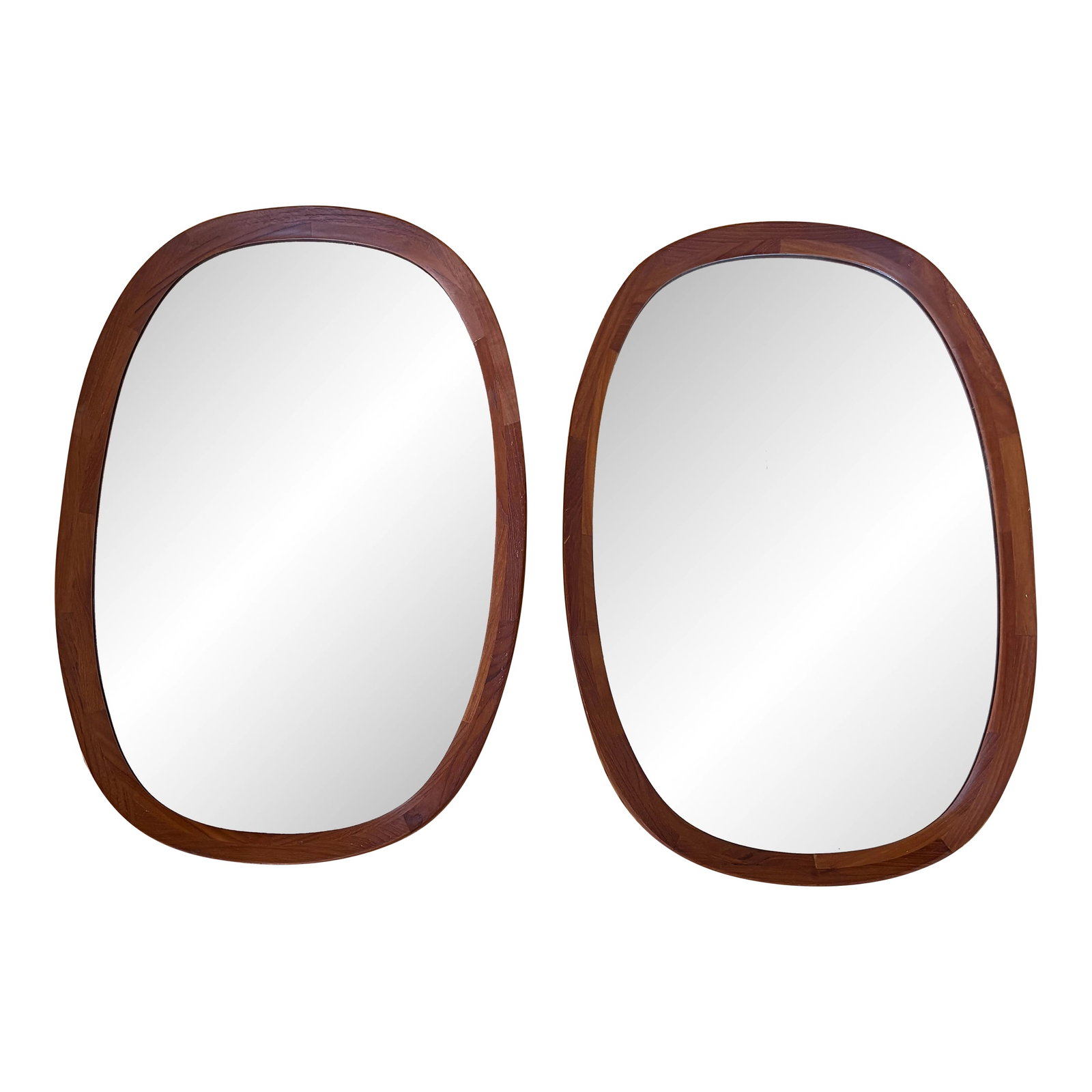 1960s Pair of Sika Mobler Teak Danish Mirrors: Gorgeous matched pair of solid teak Mobler oblong oval mirrors. Featuring a simple 1.25 inch border framing original mirrored glass. Can be hung vertically or horizontally. Both labeled with manufactu