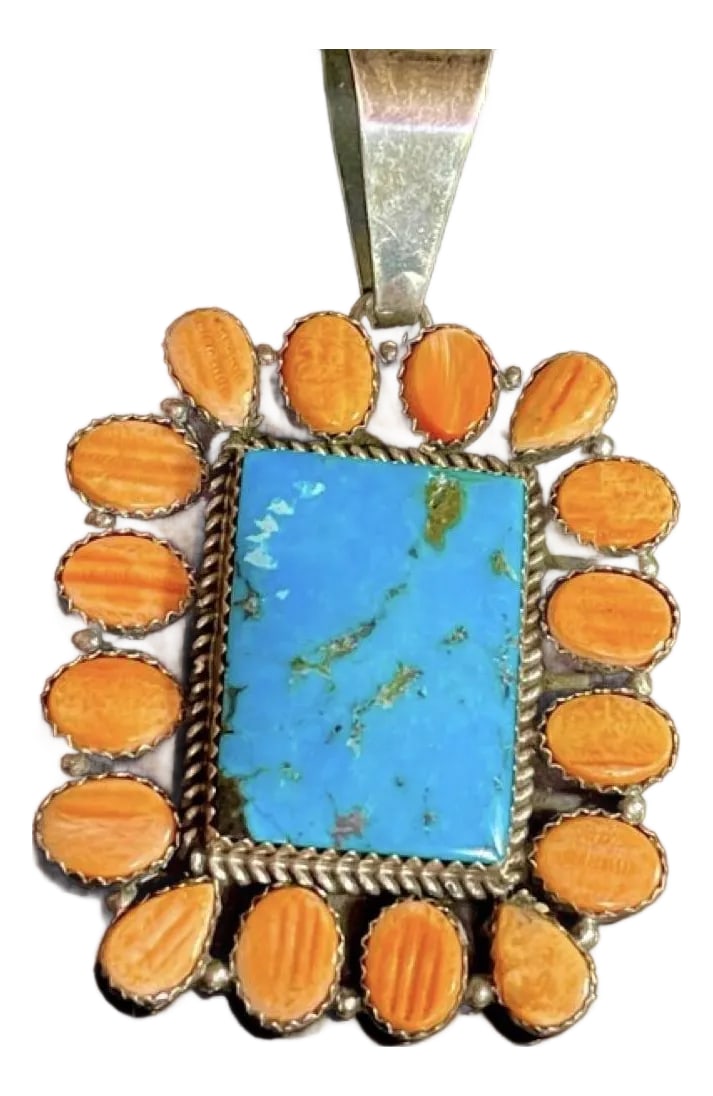 Navajo Large Sterling Silver Rectangular Pendant, Signed Daniel Mike.: Navajo large Sterling silver rectangular pendant, signed Daniel Mike. The pendant displays 16 vibrant tangerine orange spiny oyster carved cabochon stones. The spiny oyster is teardrop and oval