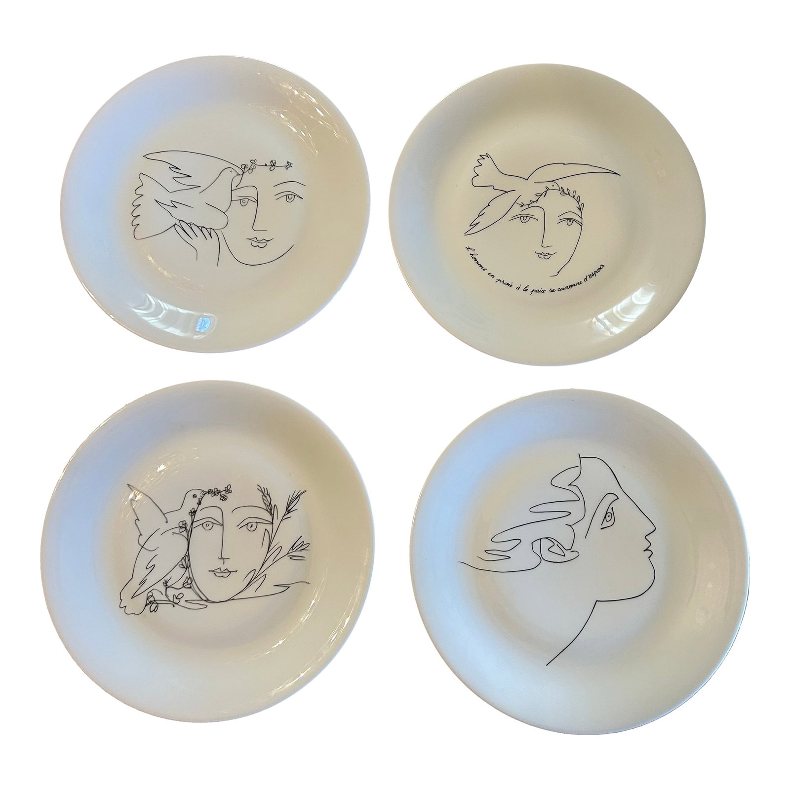 1950s Limoges Picasso Peace Plates, Set of 4: Picasso's Limoges plates stem from his broader interest in ceramics, blending high art with everyday function, especially after World War II, utilizing Limoges' fine porcelain blanks for popular editi