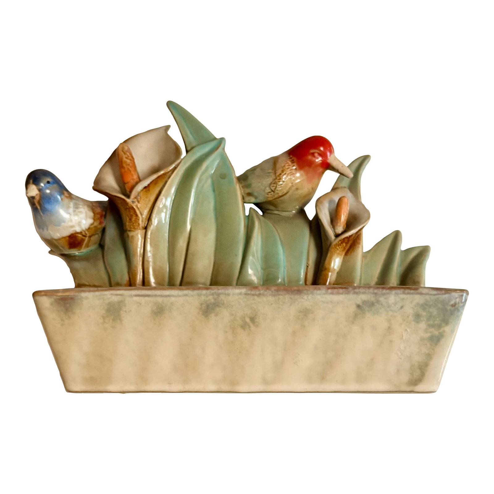 Mid 20th Century Bird and Flower Ceramic Figurine Catchall Planter: "He bops in the treetops all day long..." Rockin Robin This lovely ceramic piece features a blue jay and red robin nestled in green dimensional lilies and leaves above a rectangular trough. So is it: