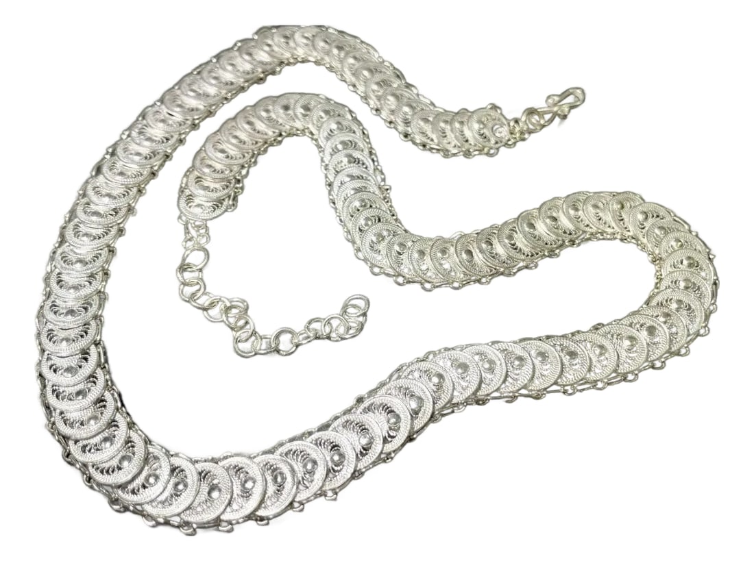 Sterling Silver Fine Filagree Articulated Disc Necklace by Amaree: This sterling silver filigree necklace features finely spun articulated discs arranged in a flexible chain design, measuring 20 inches in length. Each disc showcases the intricate filigree technique,