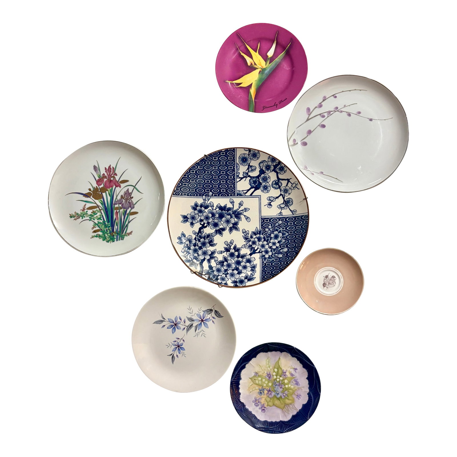 Mid 20th Century Purple and Blue Chinoiserie Blossom and Floral Wall Plate Curation, Set of 7: This beautifully curated set of seven plates has a Japanese Chinoiserie Theme featuring Cherry Blossom, Pussy Willow, Iris, Violet, and Rose floral artwork in rich shades of purple, lavender, and blue
