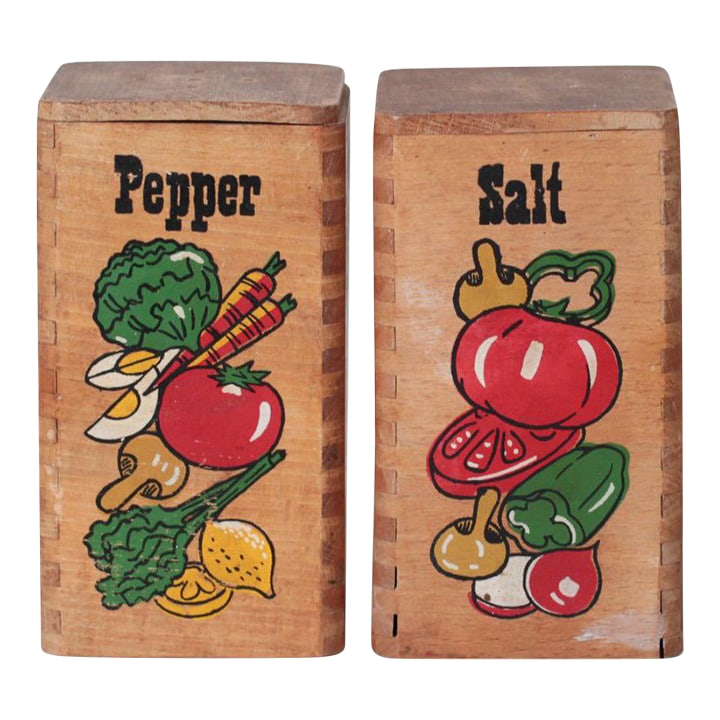 Mid-Century Wooden Salt & Pepper Shakers With Painted Vegetable Motifs: Vintage wooden salt and pepper shakers featuring hand-painted vegetable illustrations and bold lettering. Crafted in solid wood with a simple rectangular form, each shaker is front-labeled and