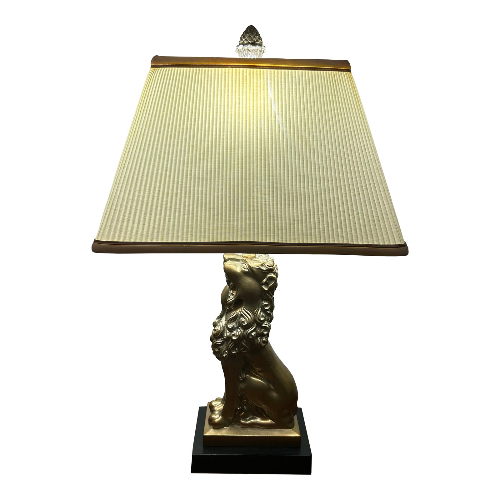 Vintage Robert Abbey Lion Lamp: An elegant statement piece by Robert Abbey. The beautifully detailed gold-toned lion sits on a black base, creating a striking contrast and timeless presence. Includes original rectangular pleated sha
