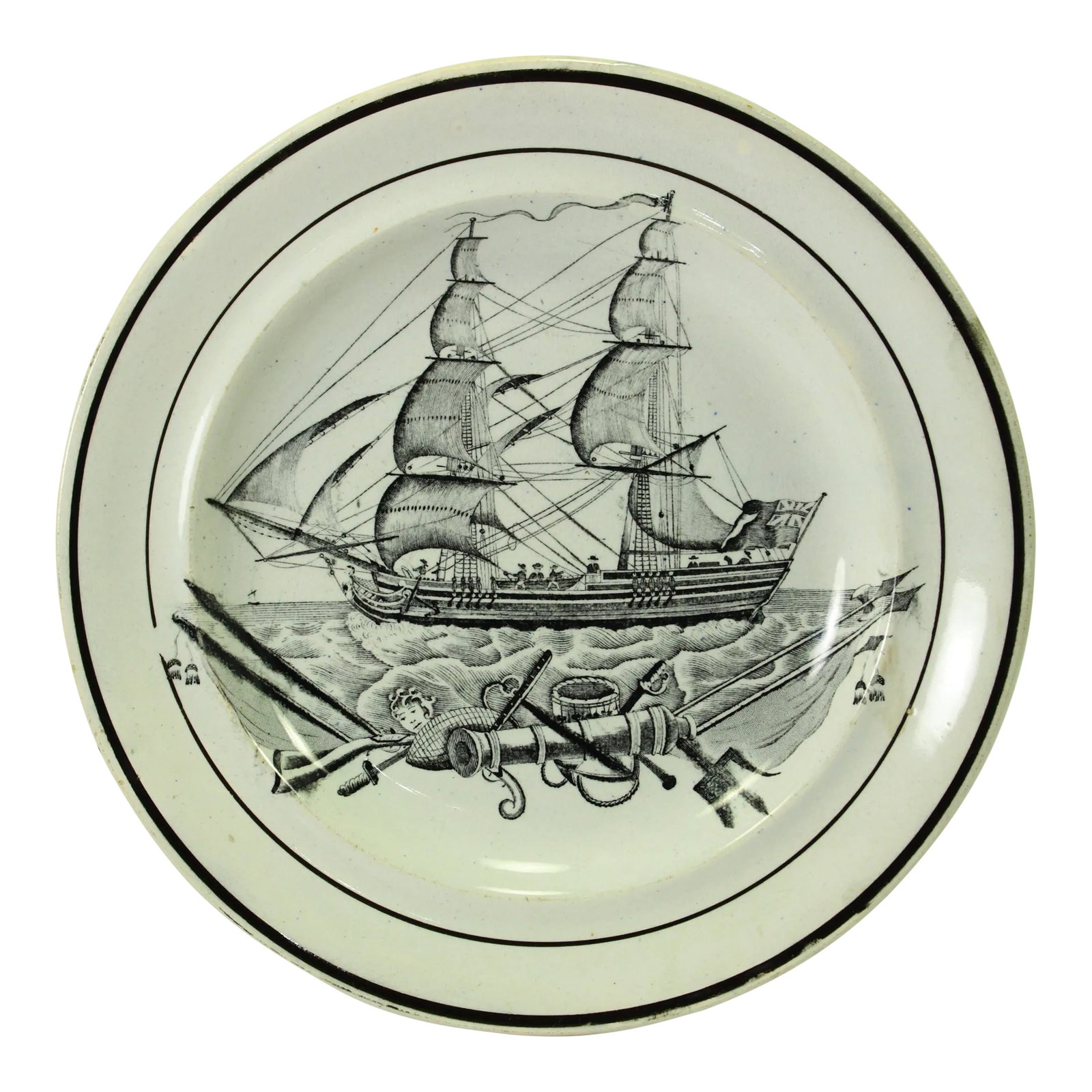 Circa 1800 Creamware Nautical Plate Ship & Trophies British Navy Ensign Herculaneum: An early creamware plate Black transfer design in the center depicting a majestic two-mast ship, a schooner or brigantine, at full sail Upfront a variety of nautical trophies and symbols are