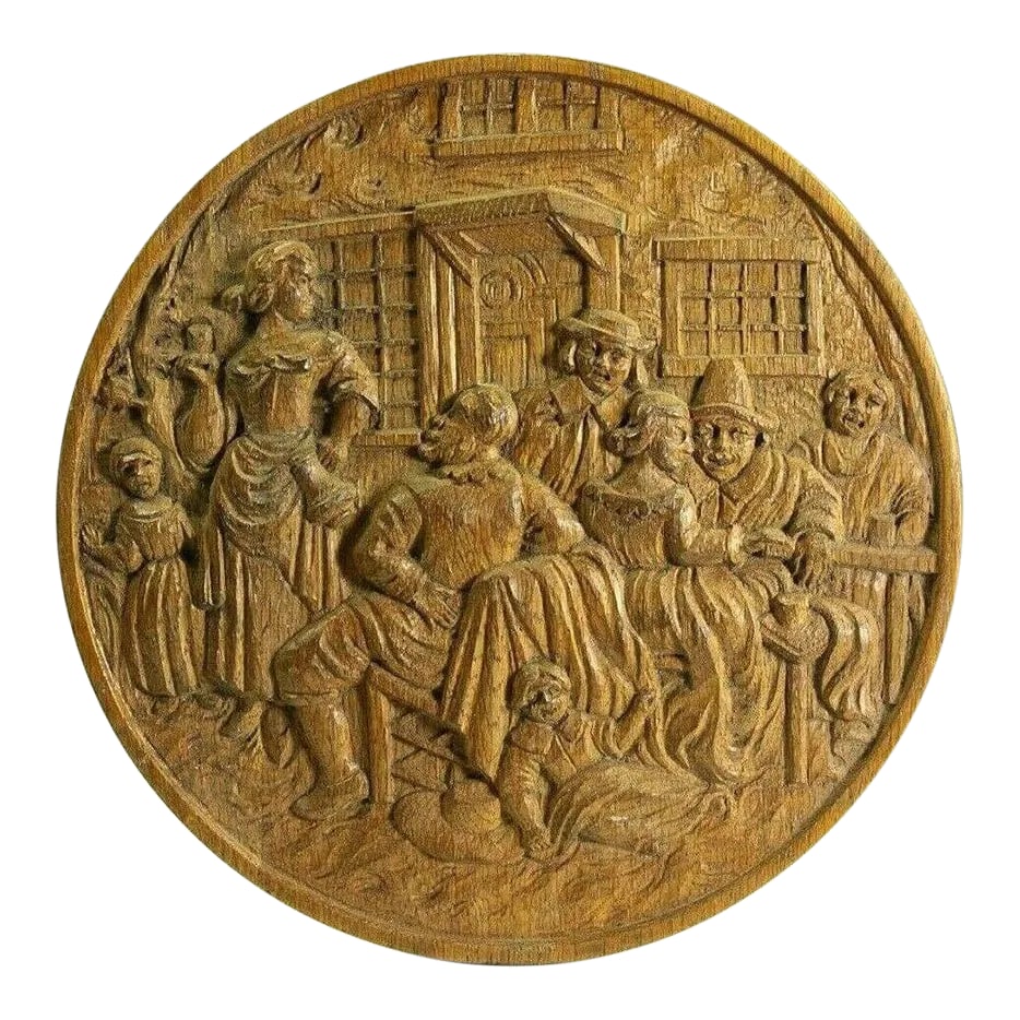 Early 19th Century Carved Wood Roundel / Plaque Bucolic Scene: A very fine early bas-relief carving A roundel or plate, depicting a joyful bucolic scene, possibly a family gathering Three man, three women and two kids are having great time around the table All
