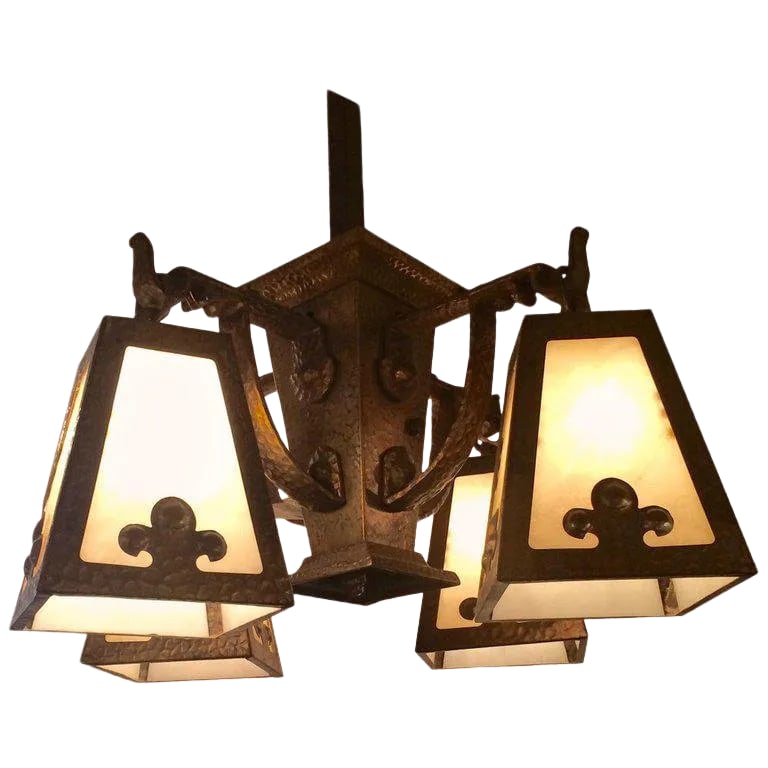 1920s Arts & Crafts Hammered Brass and Art Glass Chandelier: Impressive arts & crafts hammered brass light fixture having four white art glass shades with Fleur-de-lis motif, a long brass square rod and matching original ceiling cap. Rewired with porcelain sock