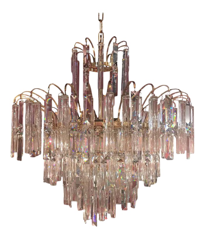 Vintage Crystal and Gold Plated Mid-Century Modern Chandelier: A breathtaking shimmering multi tiered crystal and gold chandelier with Swarovski crystals. Glitzy and sophisticated mid century modern design. The crystals are a staggered combo of round cylinders