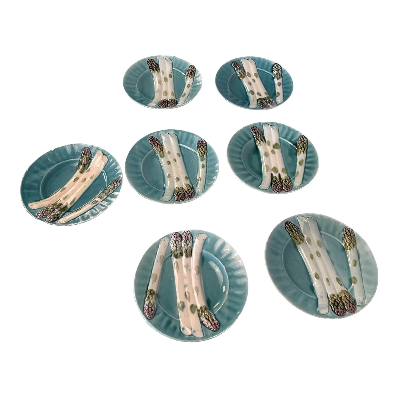 Set of Seven 1920s French Majolica Depose Kg Luneville Asparagus Plates: Lot of 7 French Majolica Depose KG Luneville asparagus plates from the Keller and Guerin Frers era. They are decorated in turquoise blue with white and green asparagus images. Decorative enough to