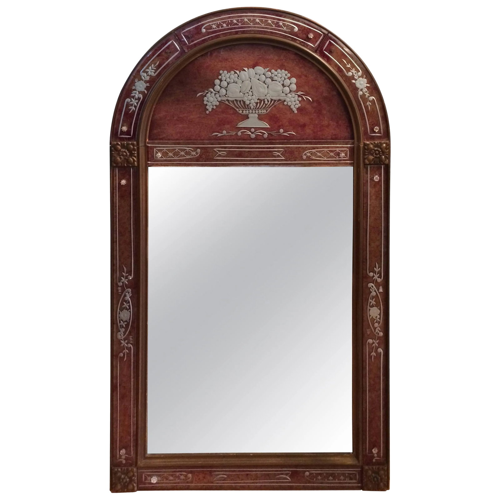 French Art Deco Mirror: Gorgeous heavy curved top eglomise mirror in Art Deco style, with faux tortoise background and foiled segmented border. Lovely brass decoration in the lower corners. Condition: Alterations: Unknown