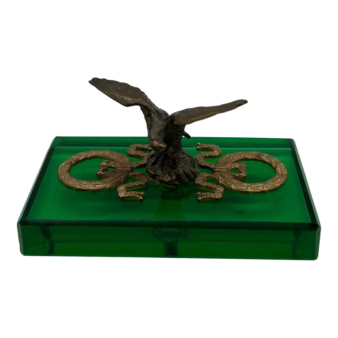 Antique French Empire Style Gilt Eagle Motif & Emerald Glass Paperweight: French, early 20th century. An antique French empire style paperweight. The paperweight features an emerald green glass base adorned with gilt bronze laurel wreaths surrounding a centralized eagle