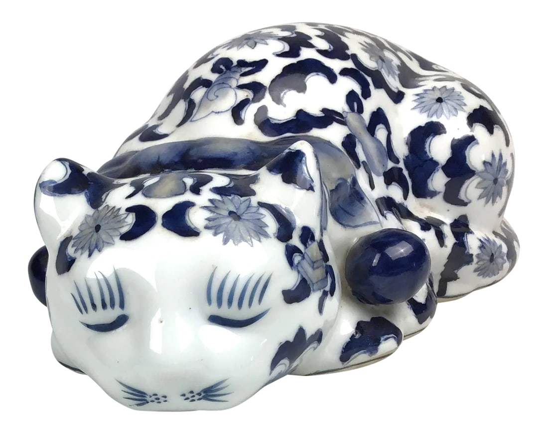 Mid Century Blue & White Porcelain Laying Cat Figurine: Sleeping porcelain cat with traditional Asian motif of treasures and florals. Hand painted and signed on the bottom. No repairs or damage. In gift worthy condition for the cat collector. Condition: