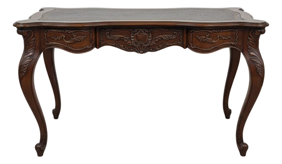 Vintage French Louis XV Style Carved Walnut Writing Desk With Leather Top: Elegant vintage writing desk crafted in the French Louis XV style, featuring graceful cabriole legs, a serpentine front, and richly carved Rococo details. The desk showcases a warm walnut finish with