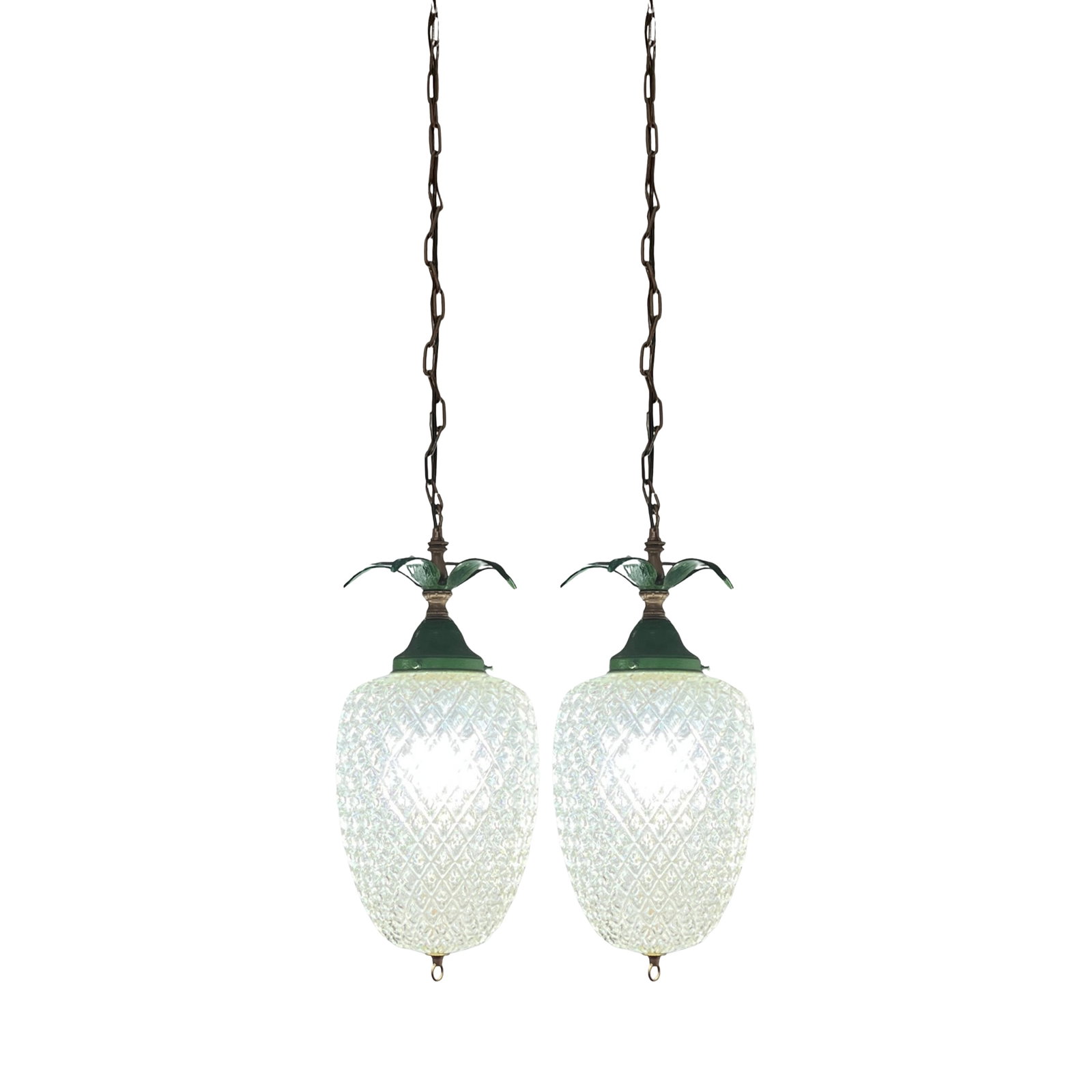 Vintage Clear Textured Glass Pineapple Pendant Lights Green Metal Leaves- A Pair: These unique 23-inch-tall pineapple pendant lights are crafted from vintage lamp components, giving them a distinctive blend of whimsy and timeless charm. The generously sized, oval clear-glass