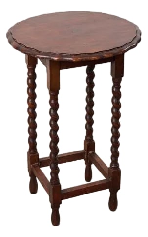 Antique English Round Oak Barley Twist Table With Scalloped Edge: This antique English round oak side table features a circular top with a scalloped edge and barley twist legs connected by squared stretchers. A versatile accent table for any space to hold decor,