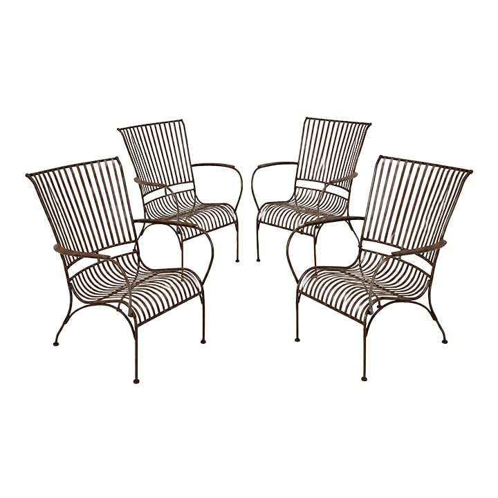 Vintage Iron Mid-Century Modern Garden Chairs: Sold as a set of 4. These vintage iron outdoor lounge chairs feature a sculptural mid-century modern design defined by clean lines and graceful curves. Crafted from slender iron rods, the chair forms 