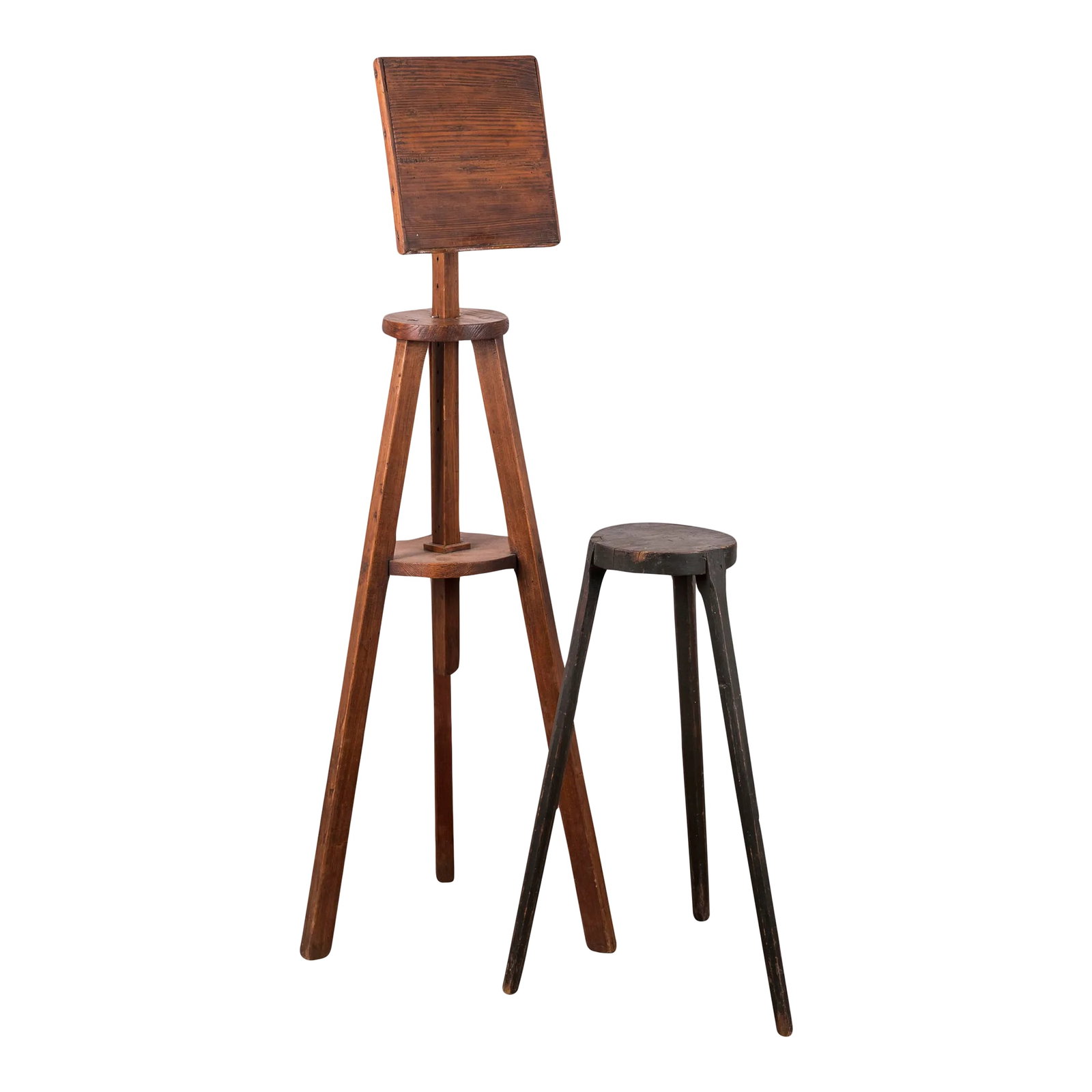 American Primitive Pine Easel & Stand, 19th Century: An American primitive pine easel and painted stand, 19th century. The easel is 17 inches wide at the legs and 48 inches tall at lowest height, adjusting up to 56 1/2 inches. The easel ledge is
