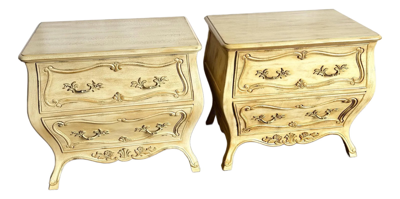 Vintage Italian Wooden Bombe Nighstands/Commodes With Cream Distressed Crackle Finish - A Pair: Rich in old-world charm, this pair of vintage Italian bombe nightstands features elegantly curved silhouettes and intricate carved florals. The cream crackle finish adds a romantic, sun-washed