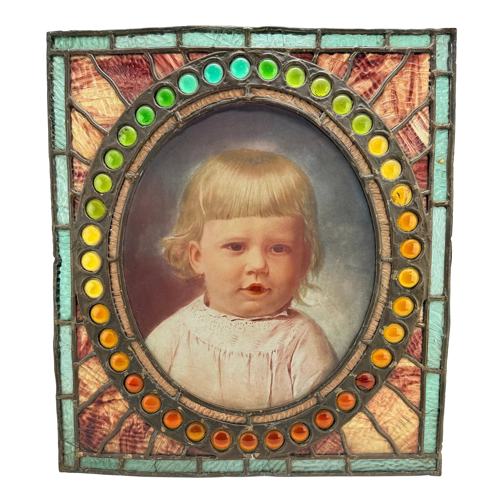 Antique American Leaded & Jeweled Glass Window of a Young Child C. 1900: Reverse glass portrait of a child in stained glass and jeweled glass frame, American, circa 1900-1910. This striking object unites the delicate intimacy of reverse glass painting with the luminous