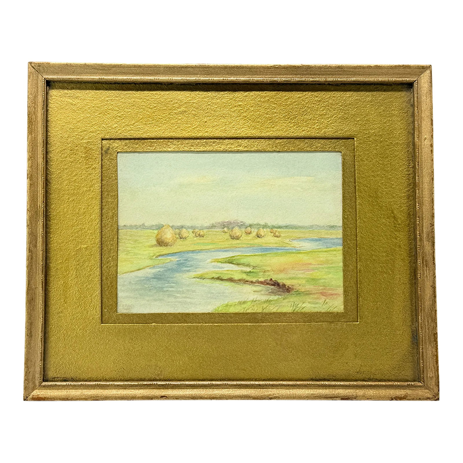 Antique American School Hayfield by the River Watercolor - Signed: This finely executed watercolor painting depicts a tranquil pastoral landscape, featuring a gently winding river bordered by verdant meadows adorned with haystacks. The artist employs soft, natural