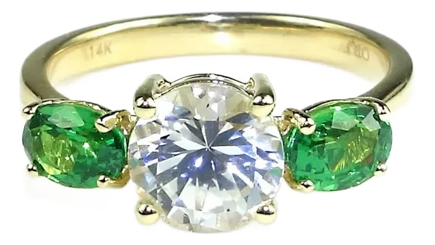 White Sapphire and Green Tsavorite 14k Yellow Gold Cocktail Ring: This exquisite, custom-made 14K Yellow Gold Ring is a stunning symbol of romance and elegance. Featuring a dazzling, round White Sapphire at the center, the ring is complemented by two brilliant oval