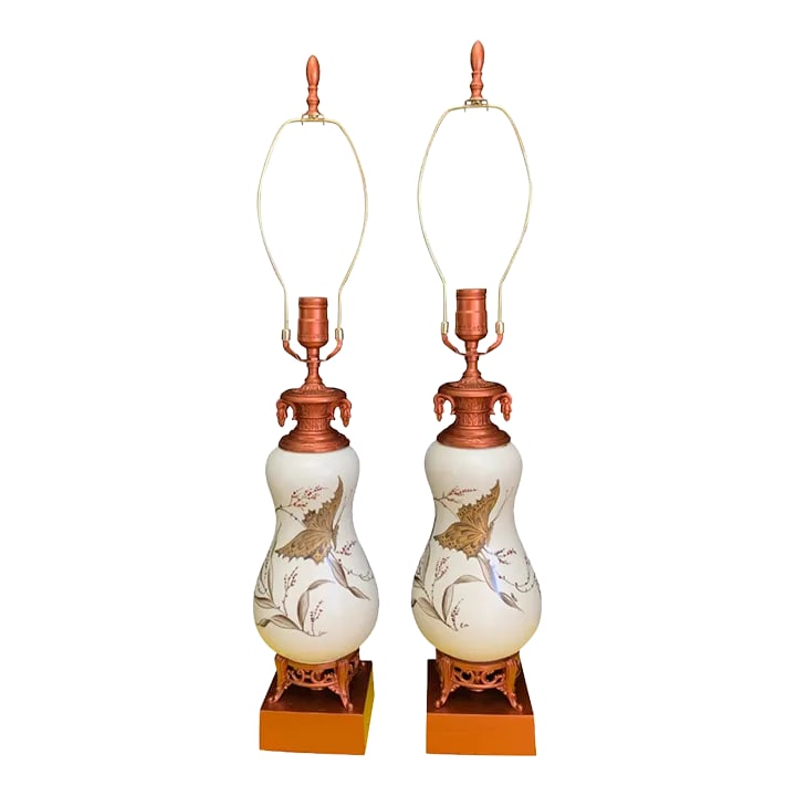 Vintage White Ceramic Gold Butterfly Table Lamps - a Pair: This exquisite mid-century table lamp showcases a gracefully hourglass-shaped white ceramic body, adorned with delicate gold butterfly motifs that impart a touch of elegance. The lamp's intricate