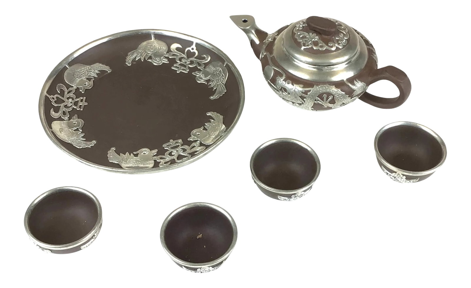 Vintage Chinese Yixing Zisha Teapot Set with Silver Tone Overlay - 6 Pieces: Yixing Zisha is famous for being the perfect material to make tea in. This set is complete with the small teapot, the 4 small cups, and a plate. Traditionally the ones drinking the tea will pour the l