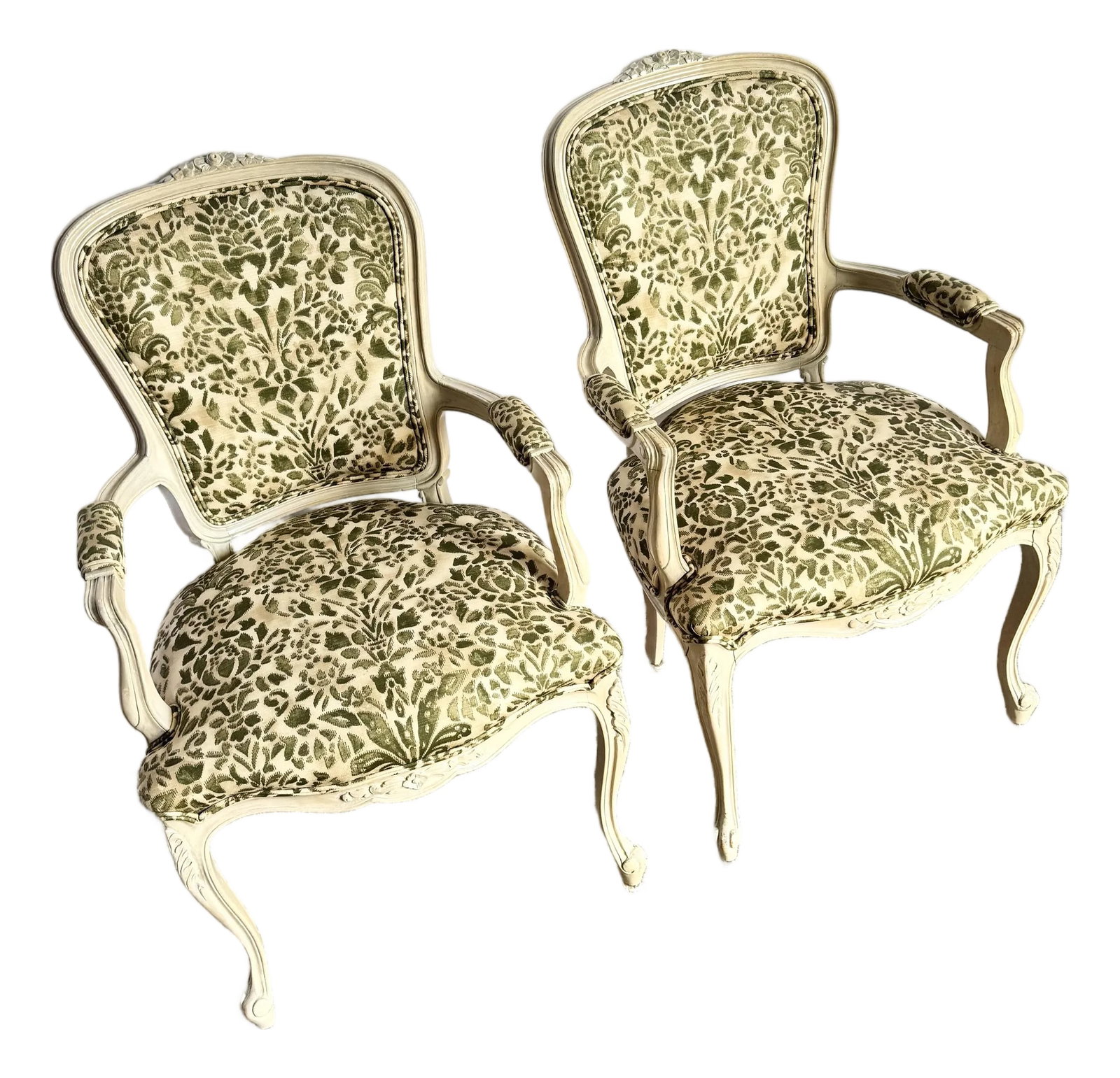 French Provincial Style Foliage Patterned Arm Chairs - A Pair: A charming pair of French Provincial-style armchairs featuring beautifully carved frames in a soft, antiqued cream finish. The seats and backs are upholstered in an elegant raised-velvet foliage