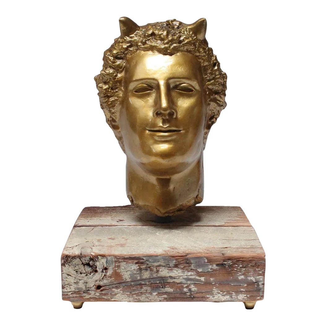Vintage Sculpture / Bust of Mythological Deity "Pan" in Painted Plaster Cast: Impressive plaster cast of the mythological deity, Pan, finished in gold paint and mounted via a steel rod to a wooden plank supported by brass orb feet (ca. 1970s, USA). Very good, lightly condition