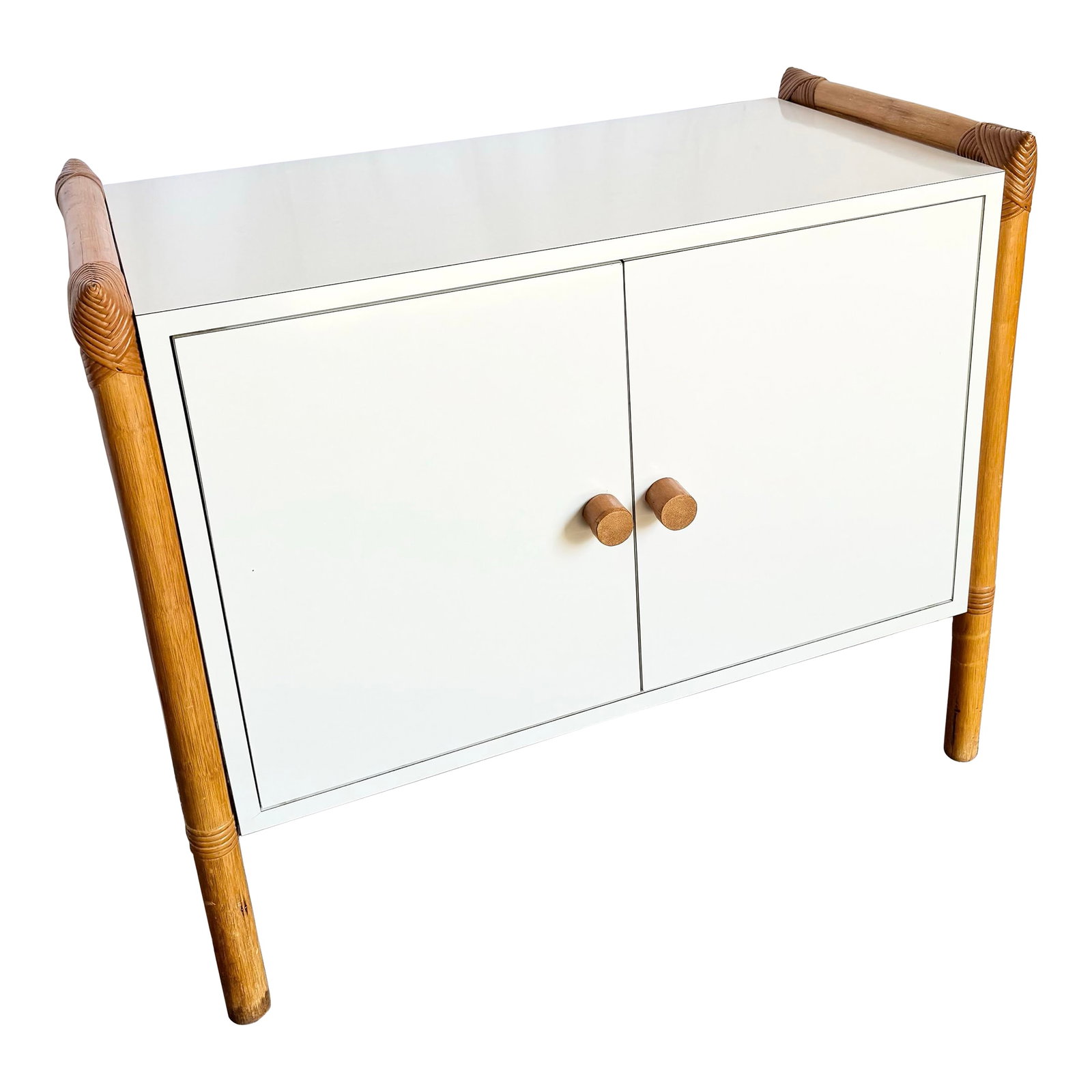 Vintage Boho Chic Rattan and White Laminate Credenza/Cabinet: This vintage Boho Chic credenza blends breezy coastal charm with clean, modern lines. Wrapped in smooth white laminate and framed by sculptural rattan posts, it strikes a rare balance between