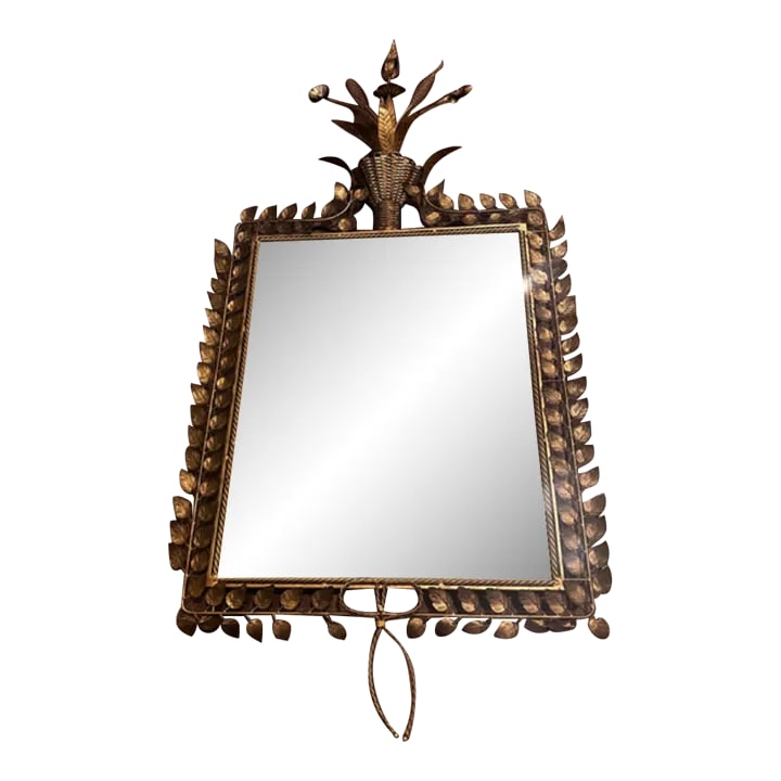 Contemporary Bunny Williams Jardin Mirror: The mirror is framed with delicate gilded leaves that meet at the top in a burst of gilded pods and flowers. One leaf has fallen off and is included 34"W x 2"D x 59.5"H ( 67" H including bottom bow)
