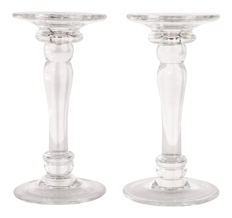 Mid-Century Modern Translucent Glass Doric Column Candlesticks: This elegant pair of Mid-Century Modern candlesticks was realized in the United States, circa 1960. Modeled after the Doric columns of ancient Greece, the piece offers a circular base and bobeche, a