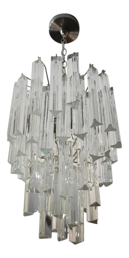 1970s Italian Triedri Crystal Prism Chandelier: Venini style tiered triedri or triedi crystal prism chandelier with nickel plated steel frame. Fixture uses 3 - 40 watt recommended B/candelabra base bulbs or any wattage LED candelabra base bulb.