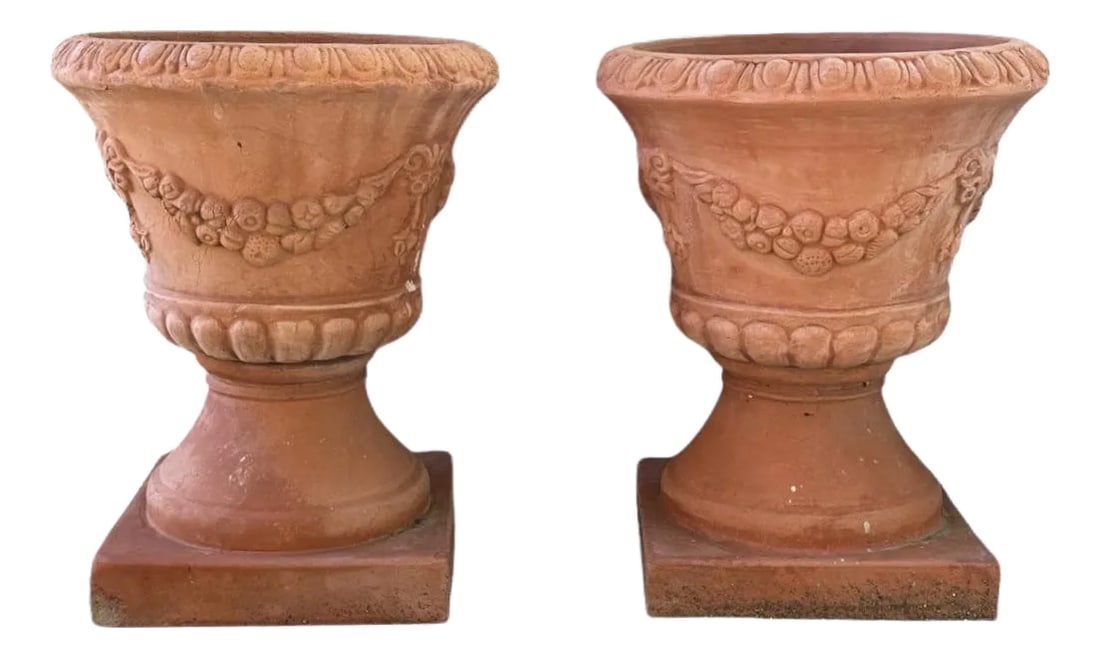 Vintage Large Neoclassical Terra Cotta Urn Planters / Terra Cotta Garden Pots, a Pair: A lovely, vintage pair of terra cotta urn planters. Each features an urn form cast in two parts, urn bowl & pedestal. Adorned with neoclassical style swags and ribbons. Unmarked. Circa late 20th Centu
