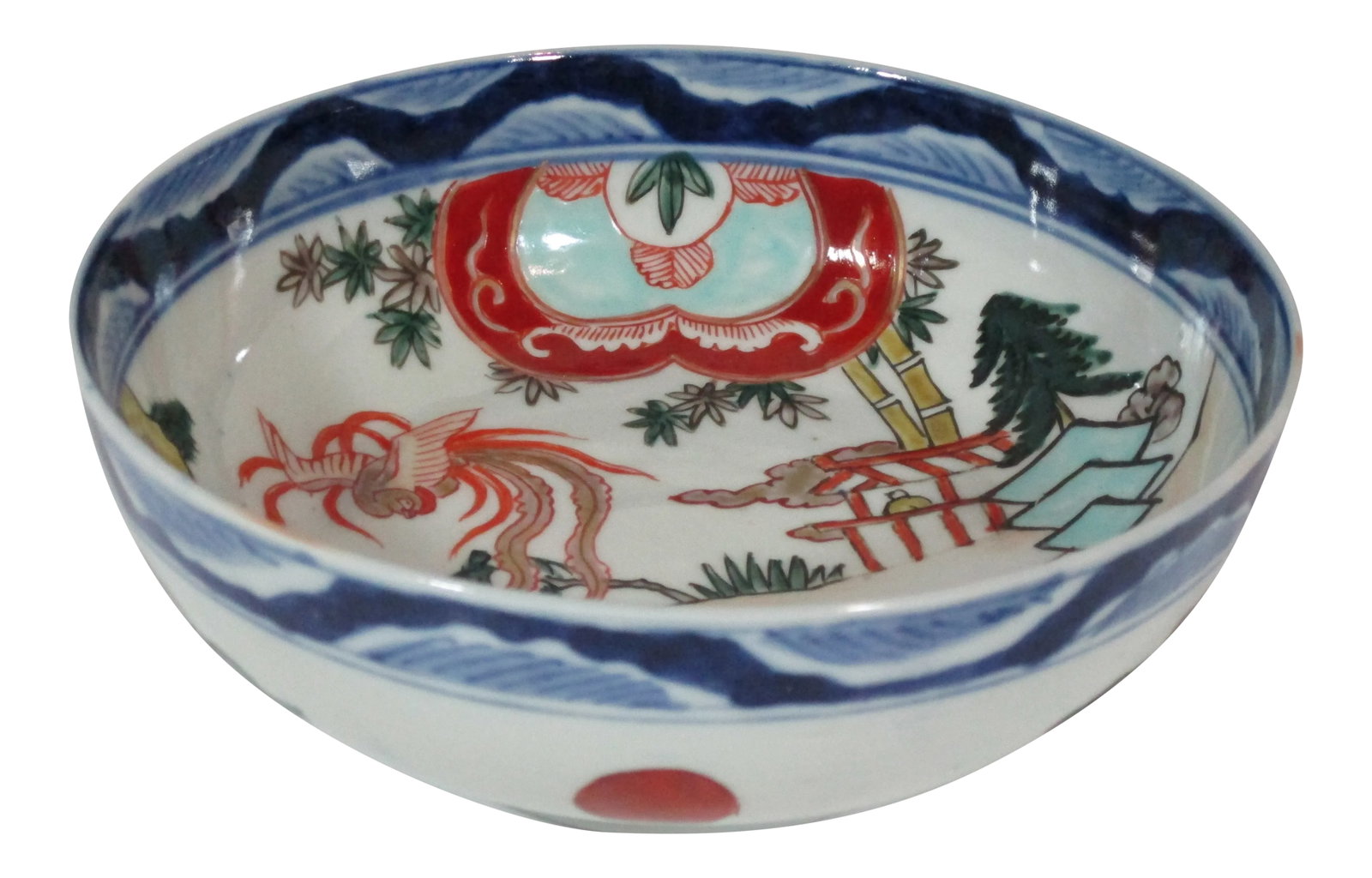 Vintage Hand Painted Imari Bowl: Vintage Japanese porcelain Imari bowl. The bowl is hand painted and decorated with a phoenix and landscape interior. The outside of the bowl is decorated with the sun and stylized clouds. A wide blue